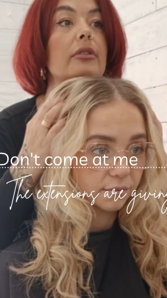 Long blonde extension waves being styled