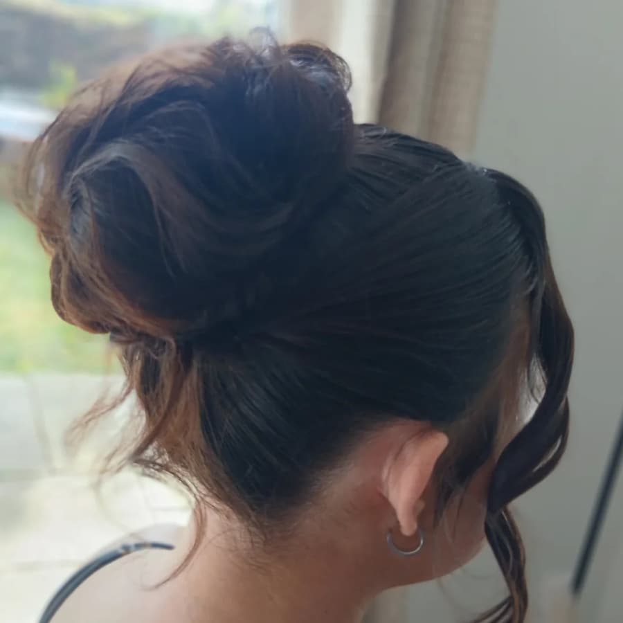 Soft dark hair up with loose face-framing pieces